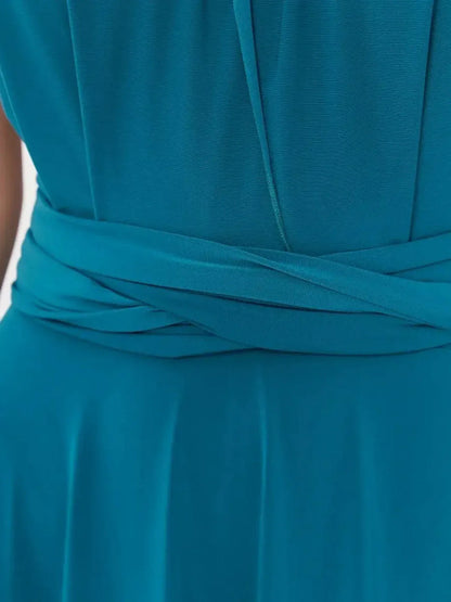 Back view of deep teal maxi dress showcasing elegant draped halter and stylish wrapped waist detail.