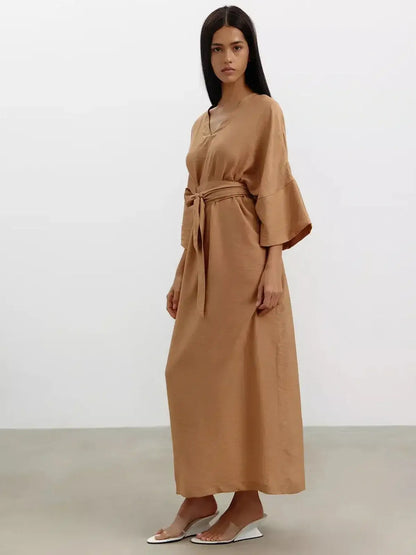 Maxi Dress Dune Whisper in sandstone hue, featuring wide sleeves and a detachable tie belt for a flattering silhouette.