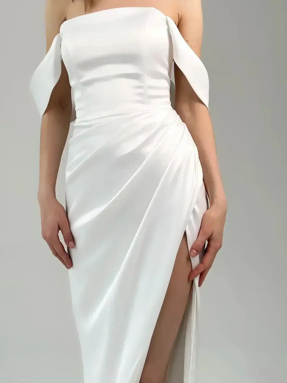 Elegant off-shoulder maxi dress with draped satin fabric and thigh-high slit, perfect for formal occasions.