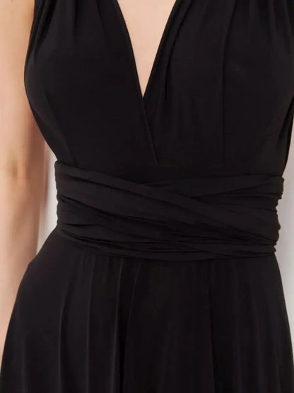 Close-up of the elegant V-neckline and draped waistband of the Maxi Dress Eclipse Drape in black.