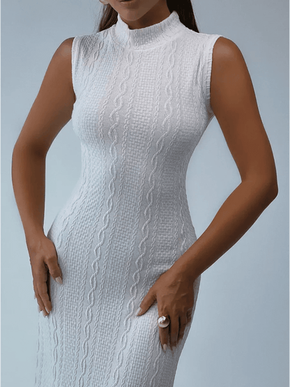 Model wearing a sleeveless white sculpted knit maxi dress with a high collar, showcasing textured jacquard design.