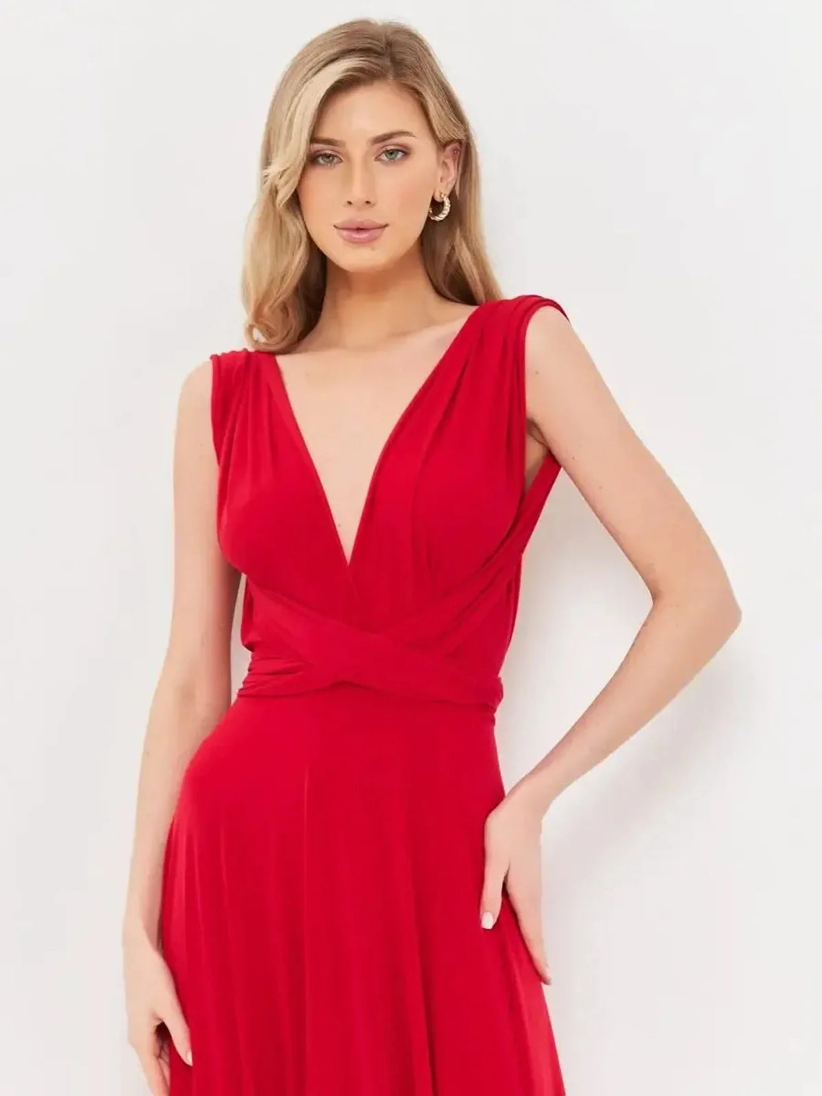 Model showcasing the backless Flame Muse maxi dress in elegant fire-red, featuring a V-neckline and flowing silhouette.