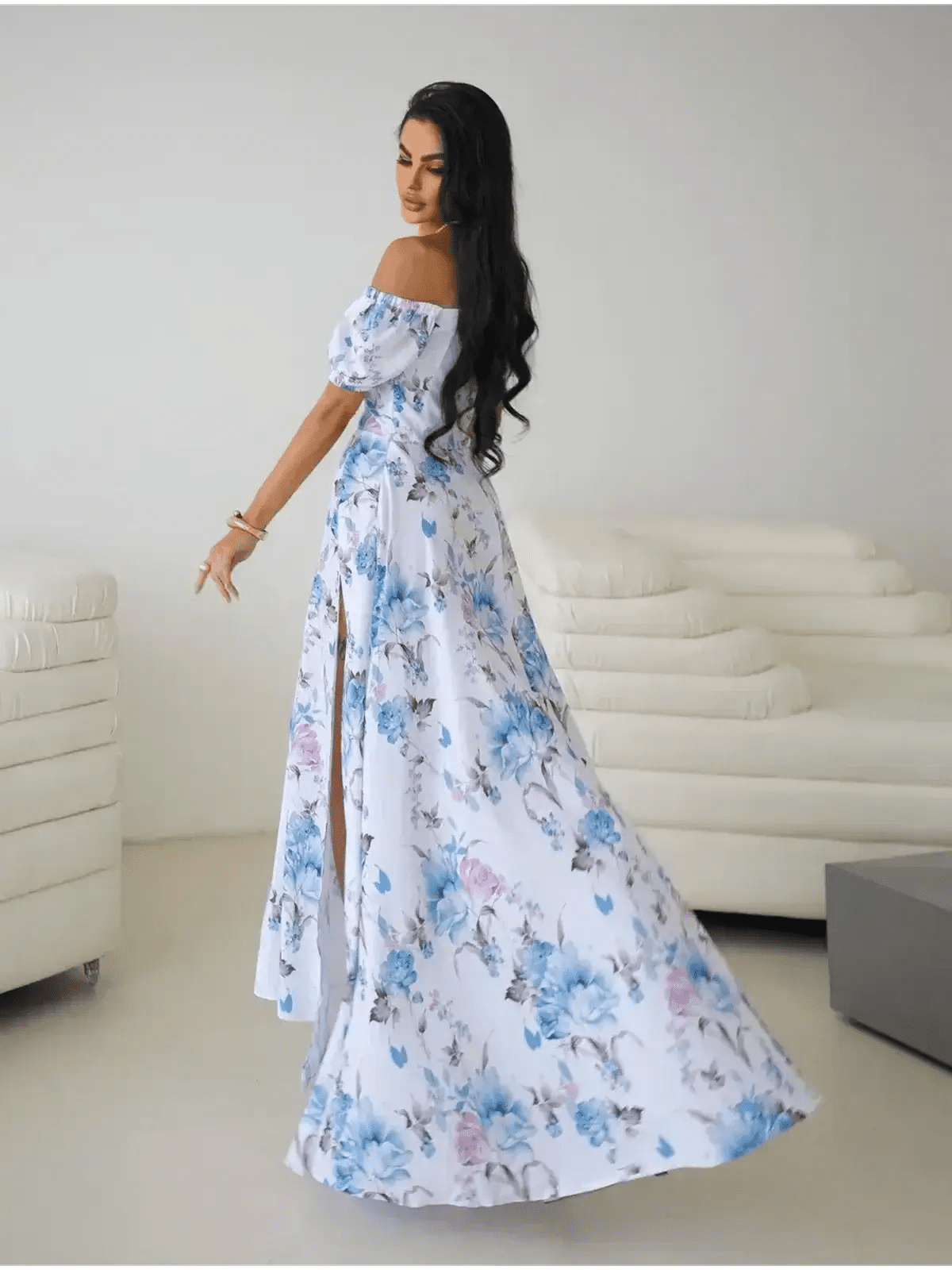 Model showcasing the Maxi Dress Fleurienne, an off-shoulder floral maxi with a thigh-high slit, exuding elegance.