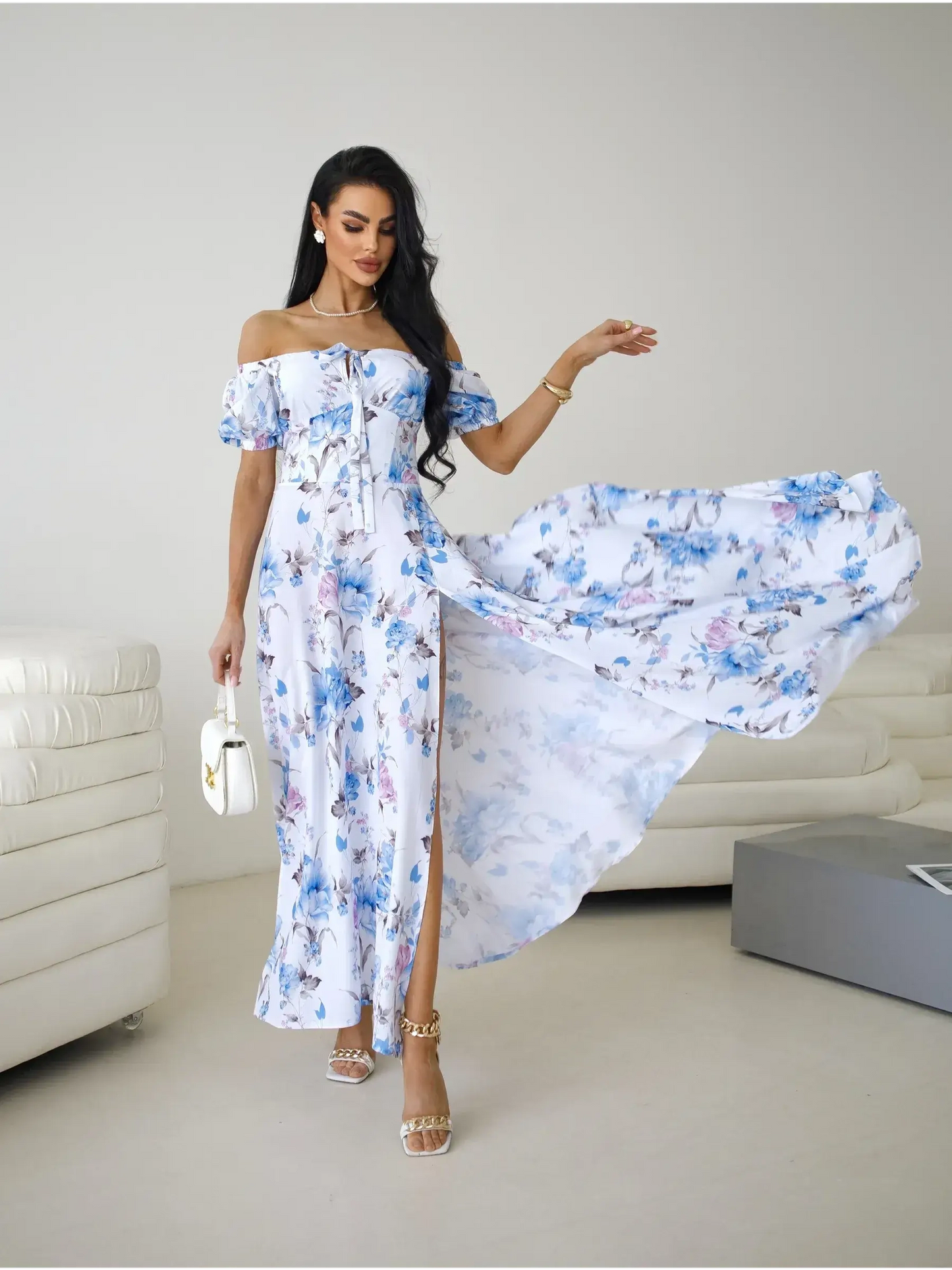 Off-shoulder floral maxi dress with flowing skirt and thigh-high slit, perfect for elegant occasions.