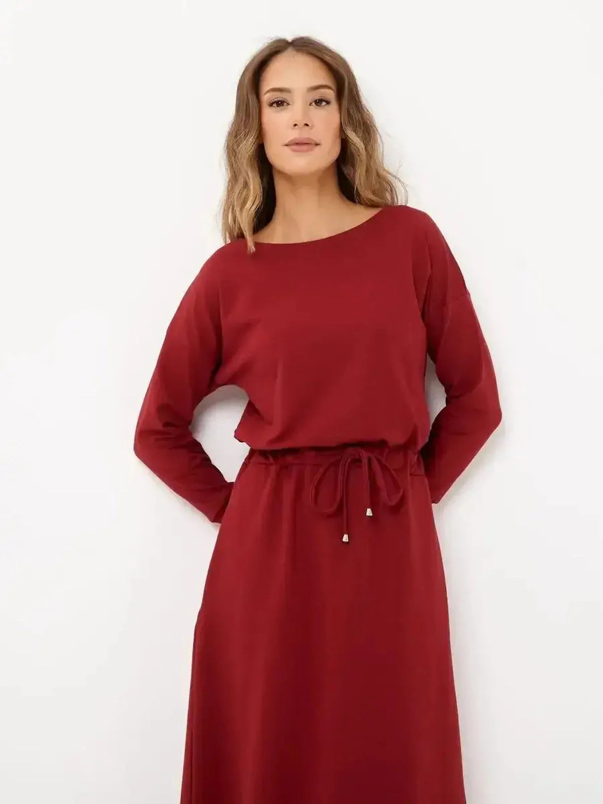 Elegant red maxi dress with long sleeves and drawstring waist, ideal for casual and formal occasions.
