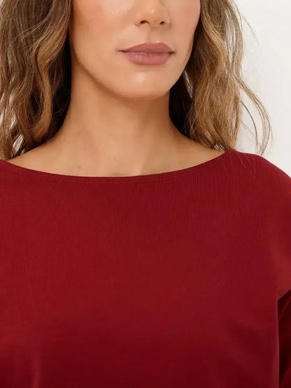 Close-up of a model wearing a red maxi dress with a boat neckline, showcasing elegance and versatile style.