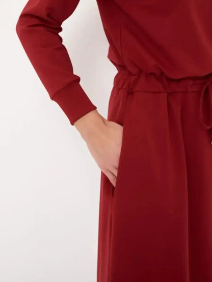 Close-up of the red Maxi Dress Graceflow featuring a drawstring waist and stylish long sleeves, ideal for elegant occasions.