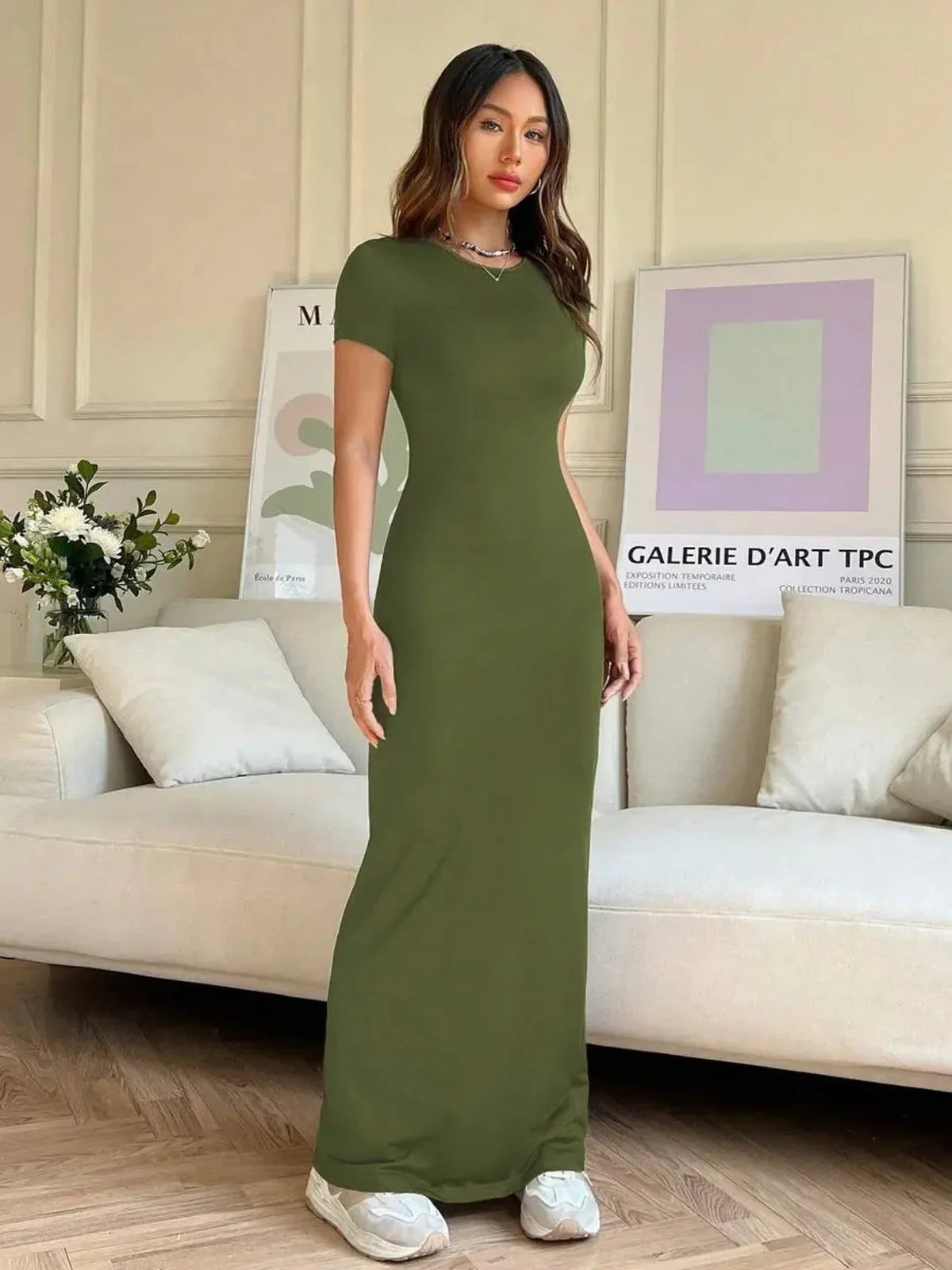 Model showcasing the Ivy Muse olive green maxi dress, highlighting its sculpting silhouette and casual elegance.