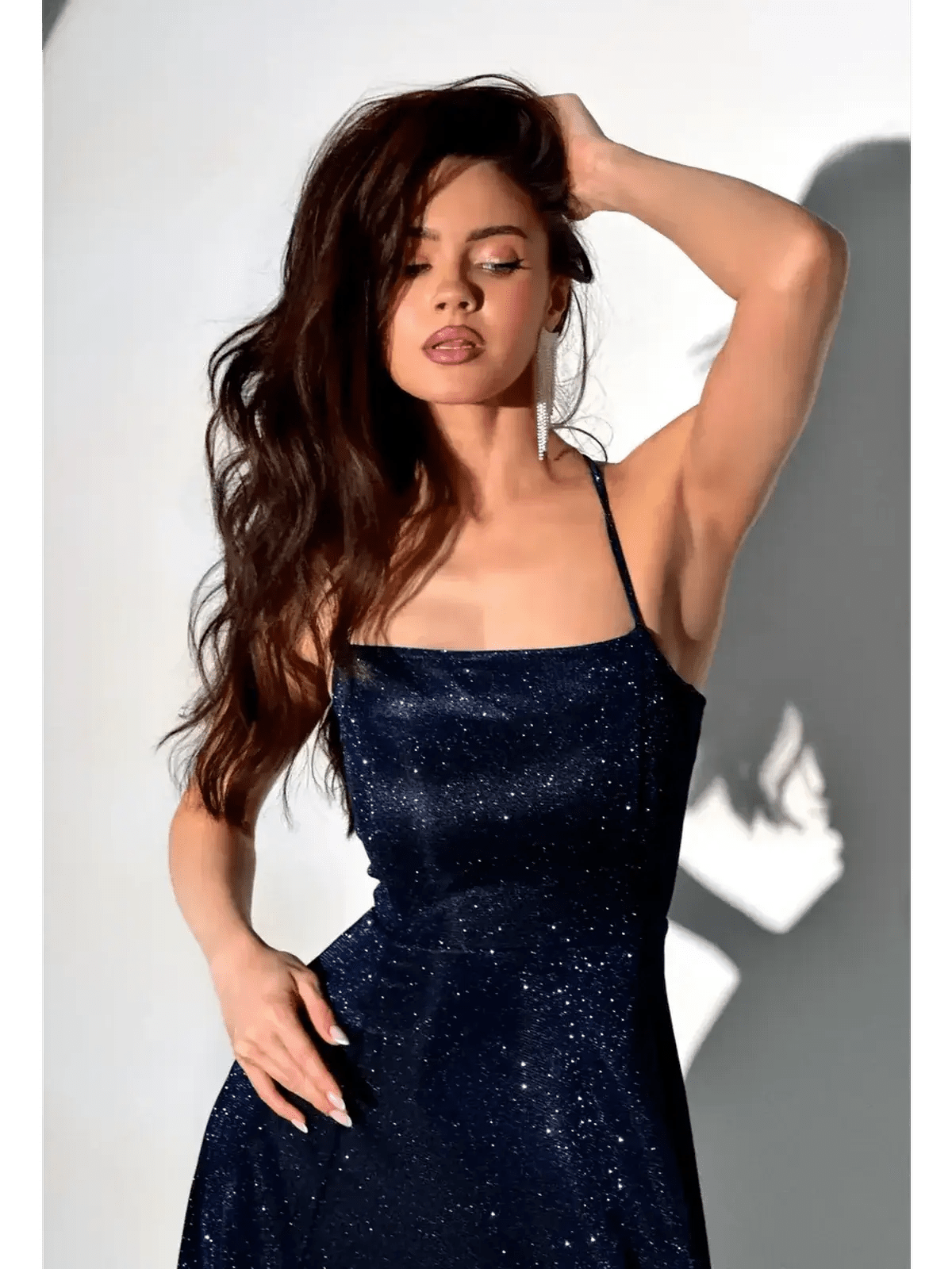 Model wearing a glittering Midnight Glint maxi dress, showcasing its elegant sparkle and sculpted fit.
