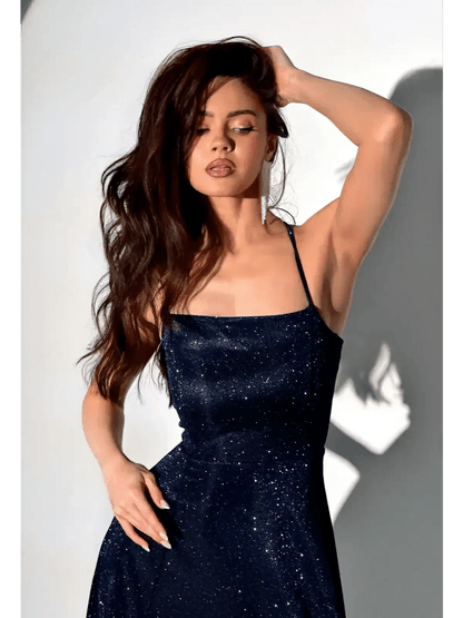 Model wearing a glittering Midnight Glint maxi dress, showcasing its elegant sparkle and sculpted fit.