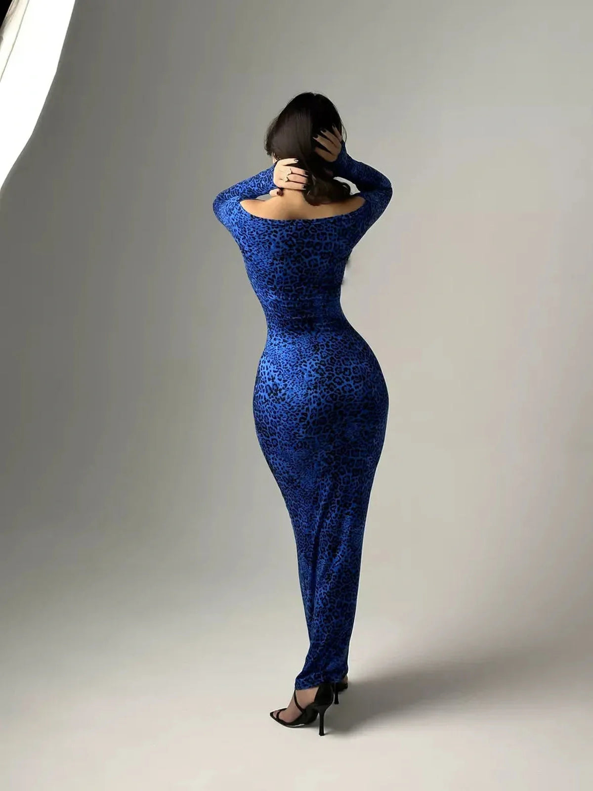 Long sleeve blue leopard print maxi dress showcasing a sleek silhouette from the back, perfect for evening events.