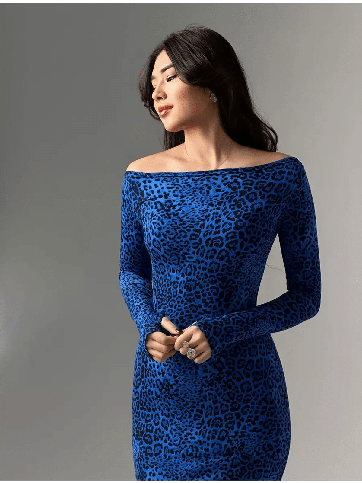 Model wearing a sleek long sleeve cobalt blue leopard print maxi dress, showcasing a flattering silhouette.