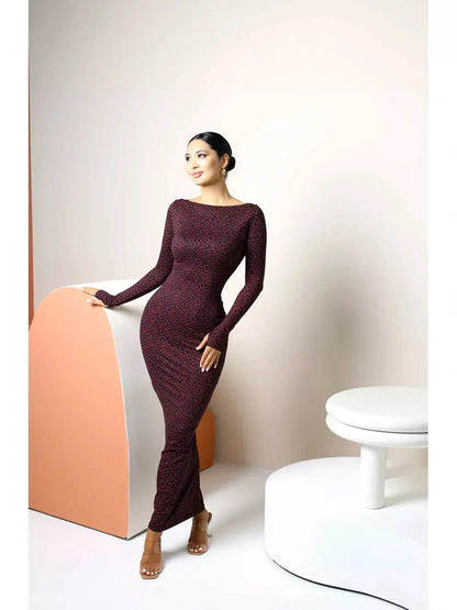 Elegant woman in a long sleeve black bodycon maxi dress with heart print, showcasing sophistication and style.
