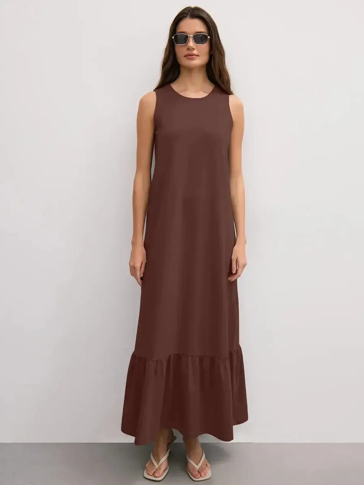 Maxi Dress Reverie in chocolate brown with sleeveless design and ruffle hem, perfect for casual elegance.