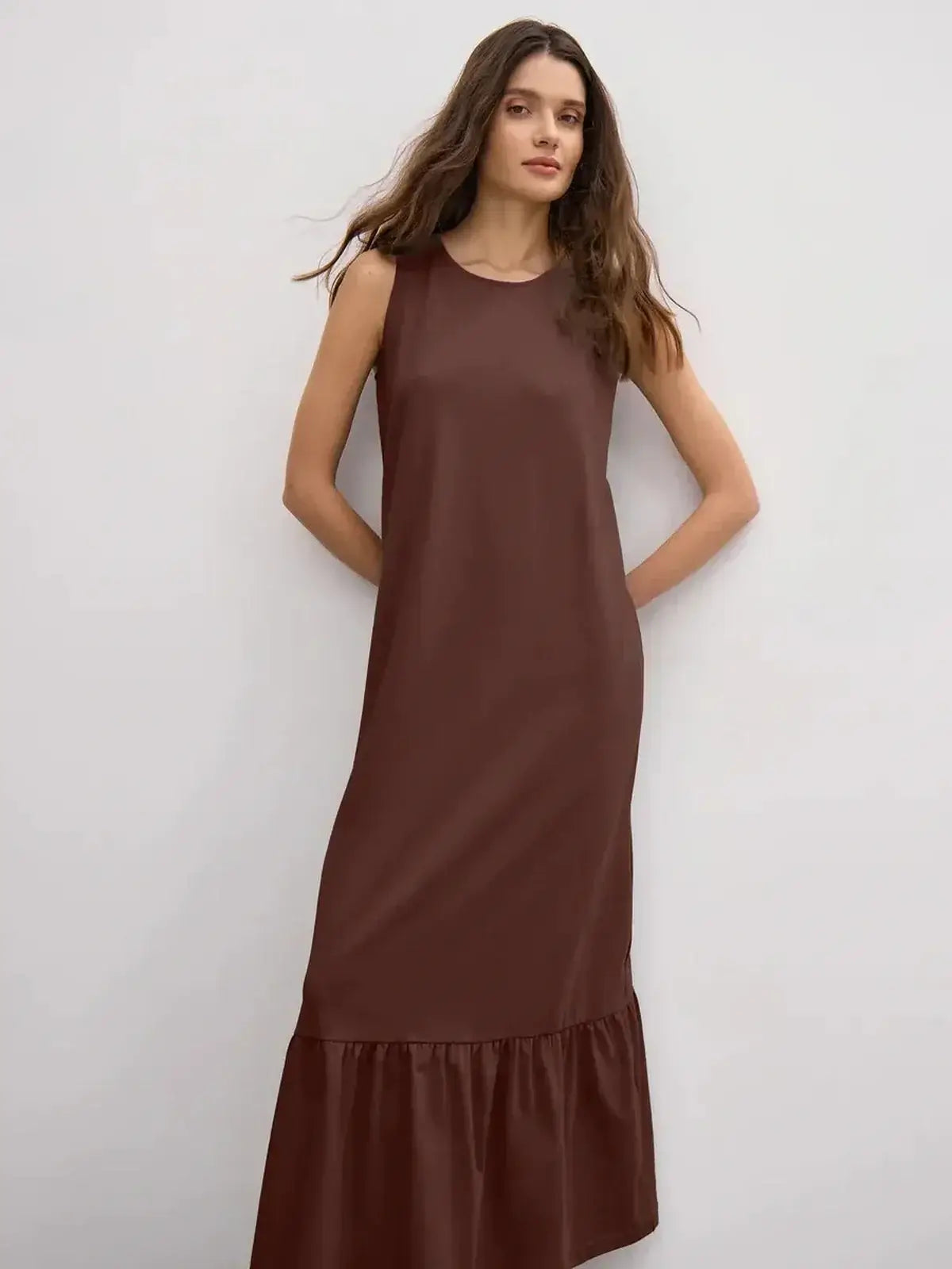 Maxi Dress Reverie in chocolate brown, featuring a sleeveless design and a ruffle hem for chic elegance.