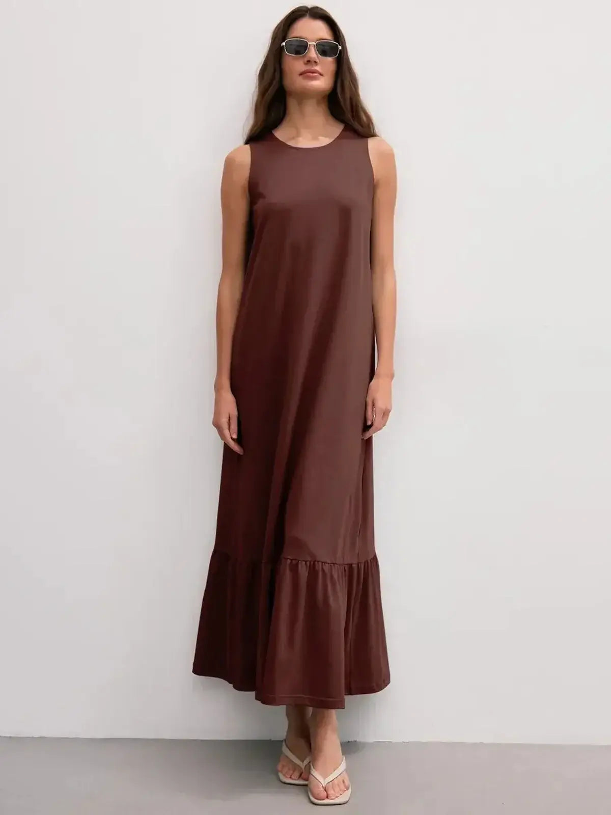 Maxi Dress Reverie in chocolate, sleeveless with ruffle hem, showcasing elegant, effortless style.