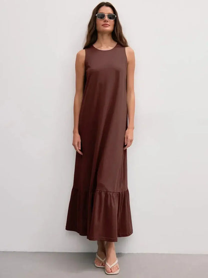 Maxi Dress Reverie in chocolate, sleeveless with ruffle hem, showcasing elegant, effortless style.