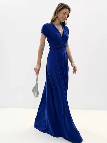 Stylish woman in a vibrant blue maxi dress with a twisted open back, perfect for formal occasions.