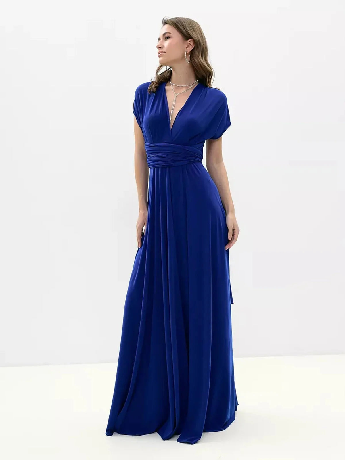 Maxi Dress Sapphire Twist featuring a flowing silhouette in vibrant blue, showcasing a twisted open back and elegant draping.