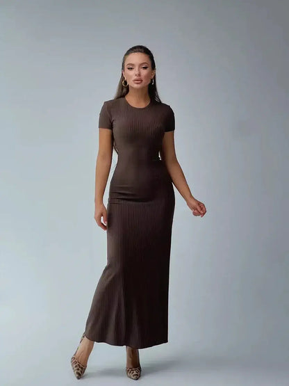 Elegant woman modeling a dark brown ribbed knit maxi dress with a sleek silhouette, perfect for casual or formal occasions.