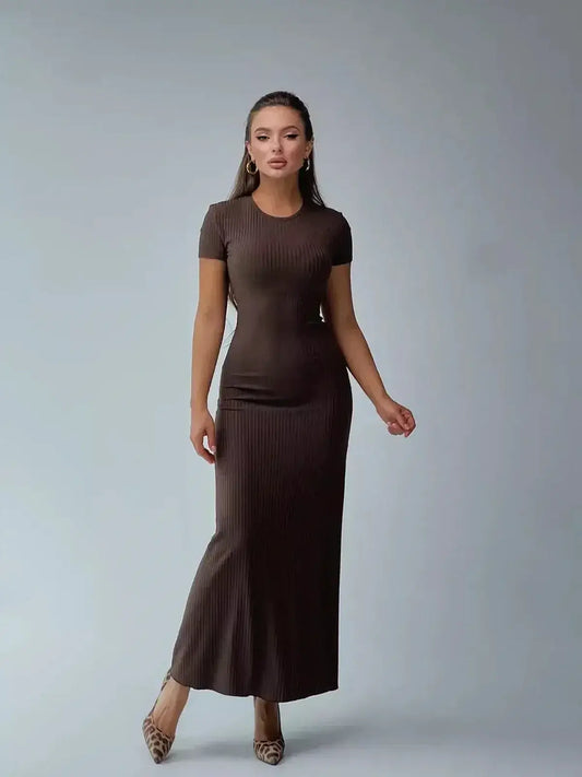 Elegant woman modeling a dark brown ribbed knit maxi dress with a sleek silhouette, perfect for casual or formal occasions.