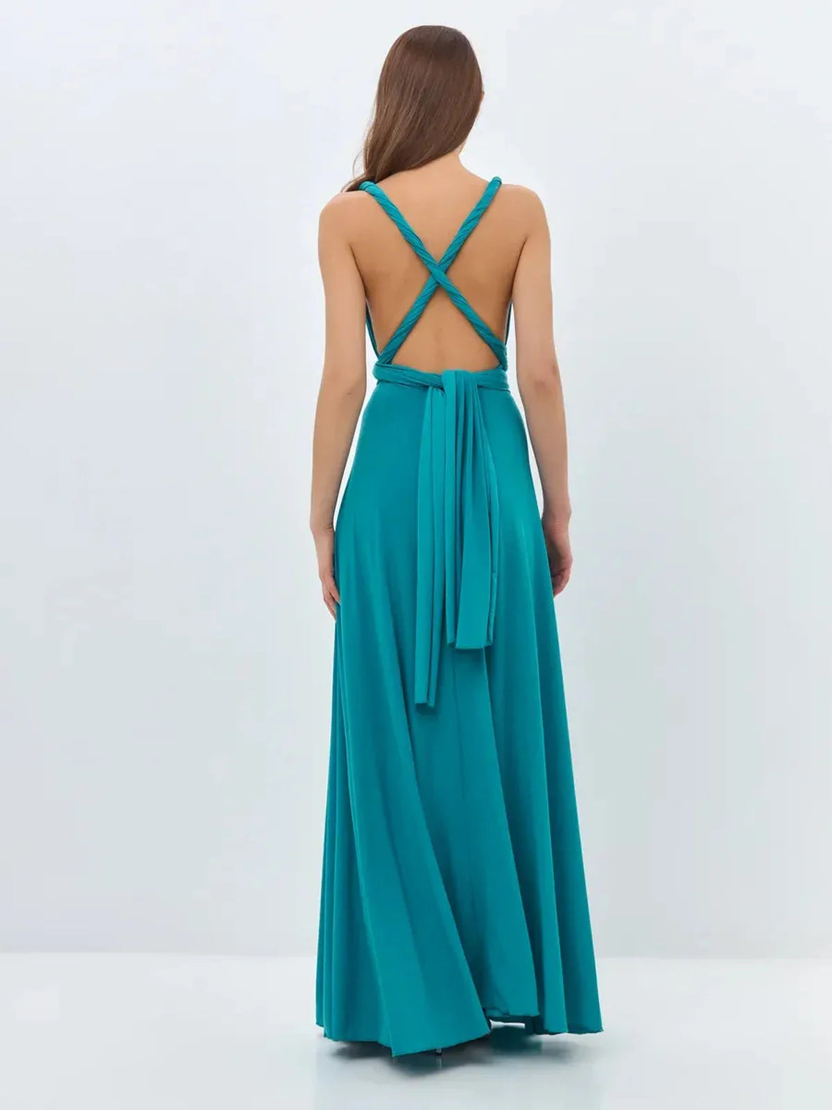Back view of the teal Maxi Dress Serenity Flow with crisscross straps and flowing silhouette, ideal for elegant occasions.