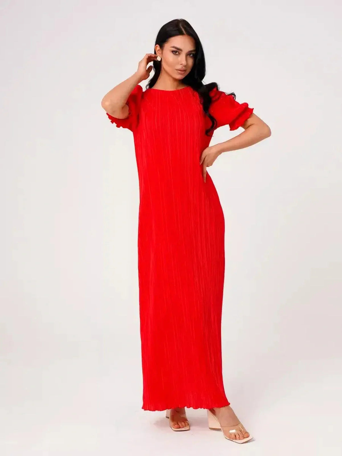 Model wears a vibrant red pleated maxi dress with puff sleeves, perfect for summer events and special occasions.