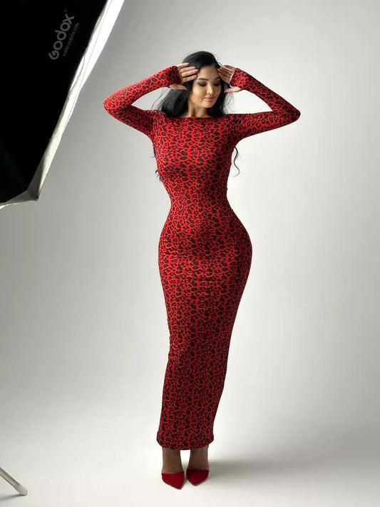 Model showcasing the Wild Inferno Maxi Dress in red leopard print, featuring a curve-hugging silhouette and long sleeves.