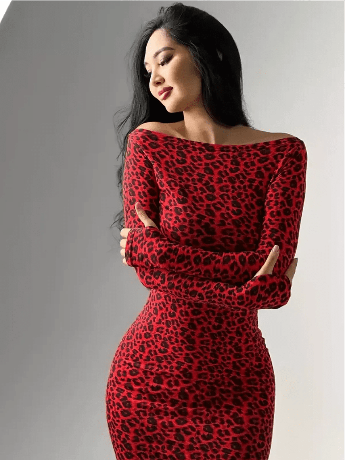 Woman in red leopard print off-shoulder maxi dress, showcasing a curve-hugging silhouette and confident elegance.