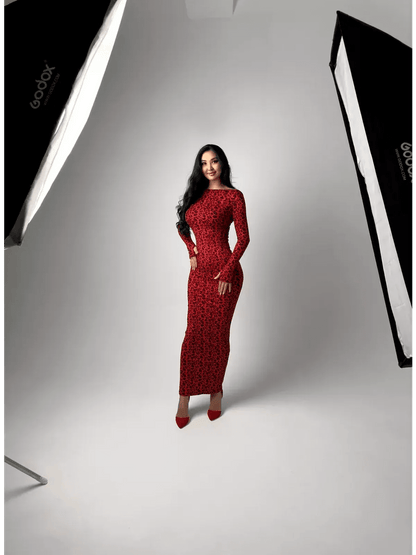 Model wearing the Wild Inferno Maxi Dress, featuring a bold leopard print and long sleeves, exuding confidence and elegance.