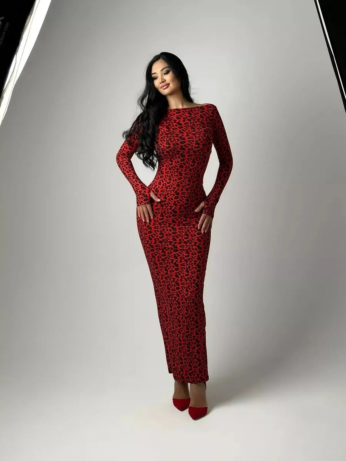 Model wearing the Wild Inferno Maxi Dress featuring a bold leopard print and curve-contouring silhouette.