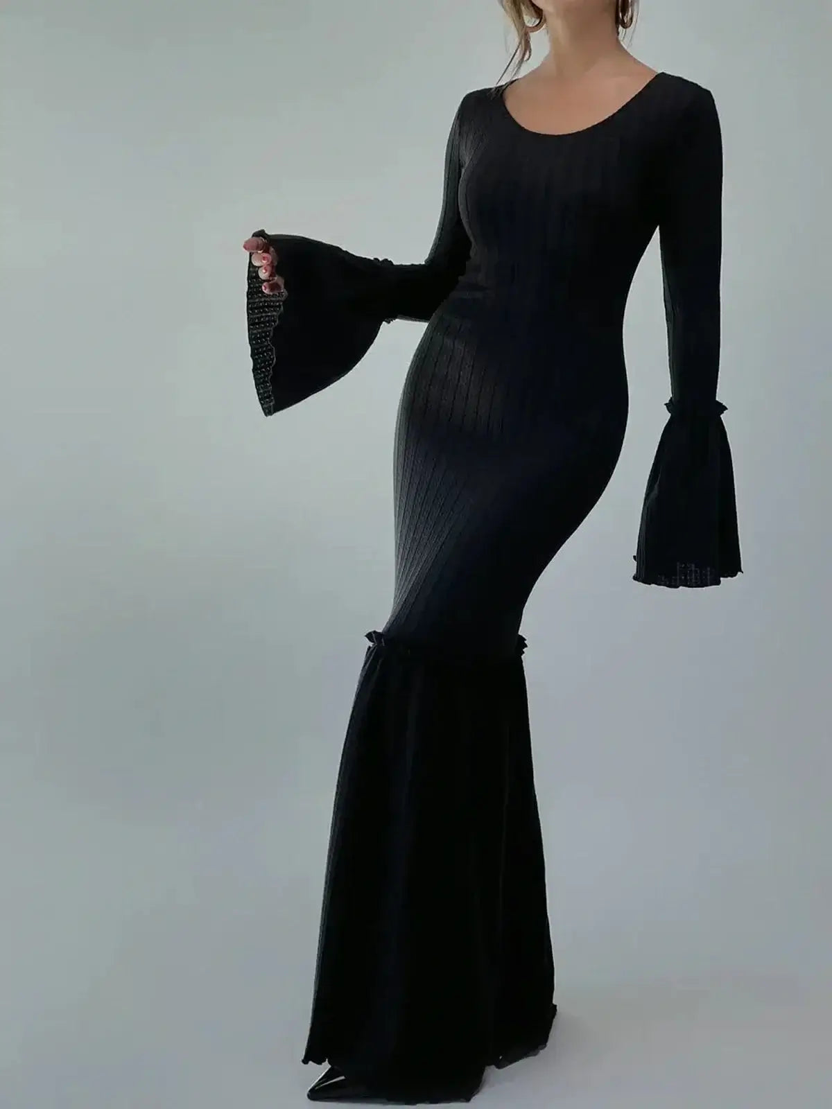 Meridian Maxi Dress showcasing sculpted elegance with flared cuffs and hem, ideal for upscale events.