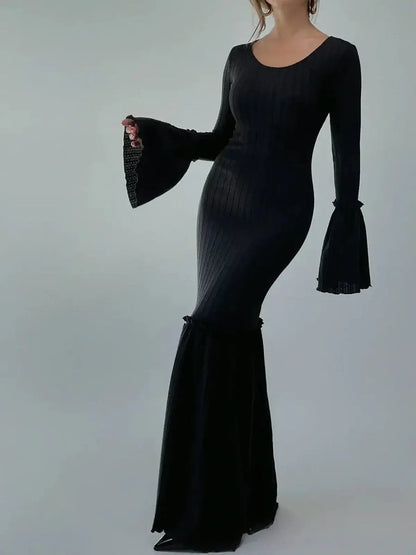 Meridian Maxi Dress showcasing sculpted elegance with flared cuffs and hem, ideal for upscale events.
