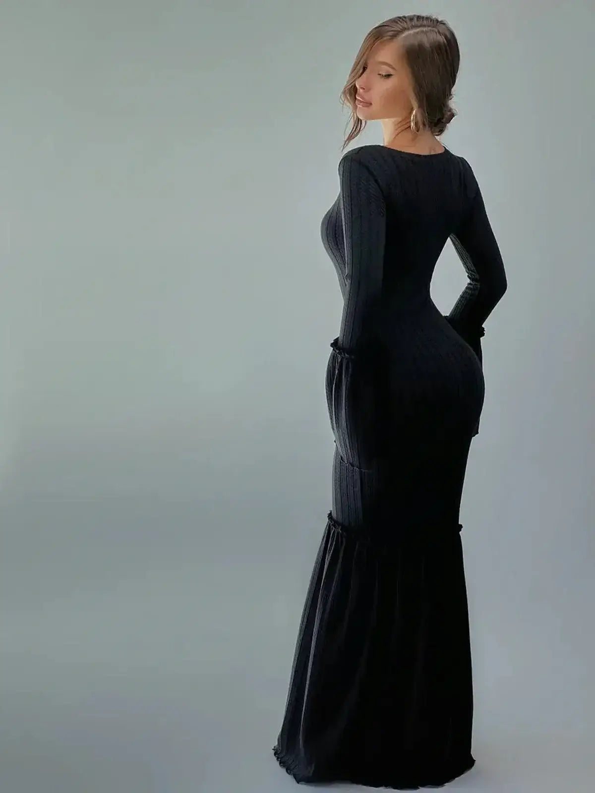 Elegant black Meridian Maxi Dress featuring a sculpted fit, long sleeves, and flared cuffs, perfect for upscale events.