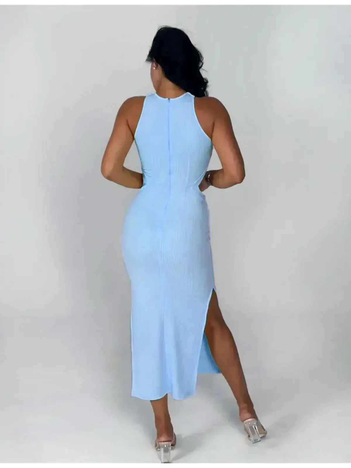 Back view of Midi Dress Azure Charm in light blue, featuring a ribbed knit, halter neck, and bold side slit.