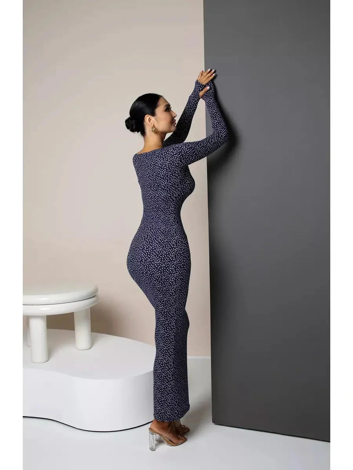 Model showcasing the Midnight Curve Maxi Dress with a sculpting fit and elegant silhouette in dark navy.