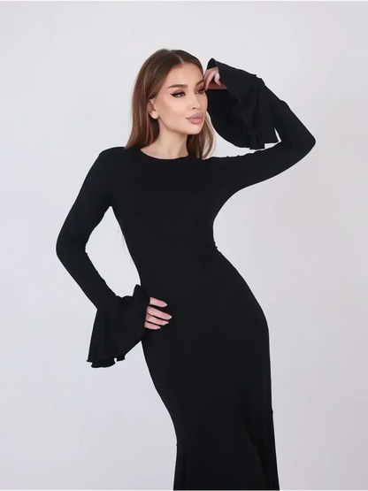 Model showcasing the elegant Mirage Maxi Dress with flared cuffs, perfect for formal evening wear.