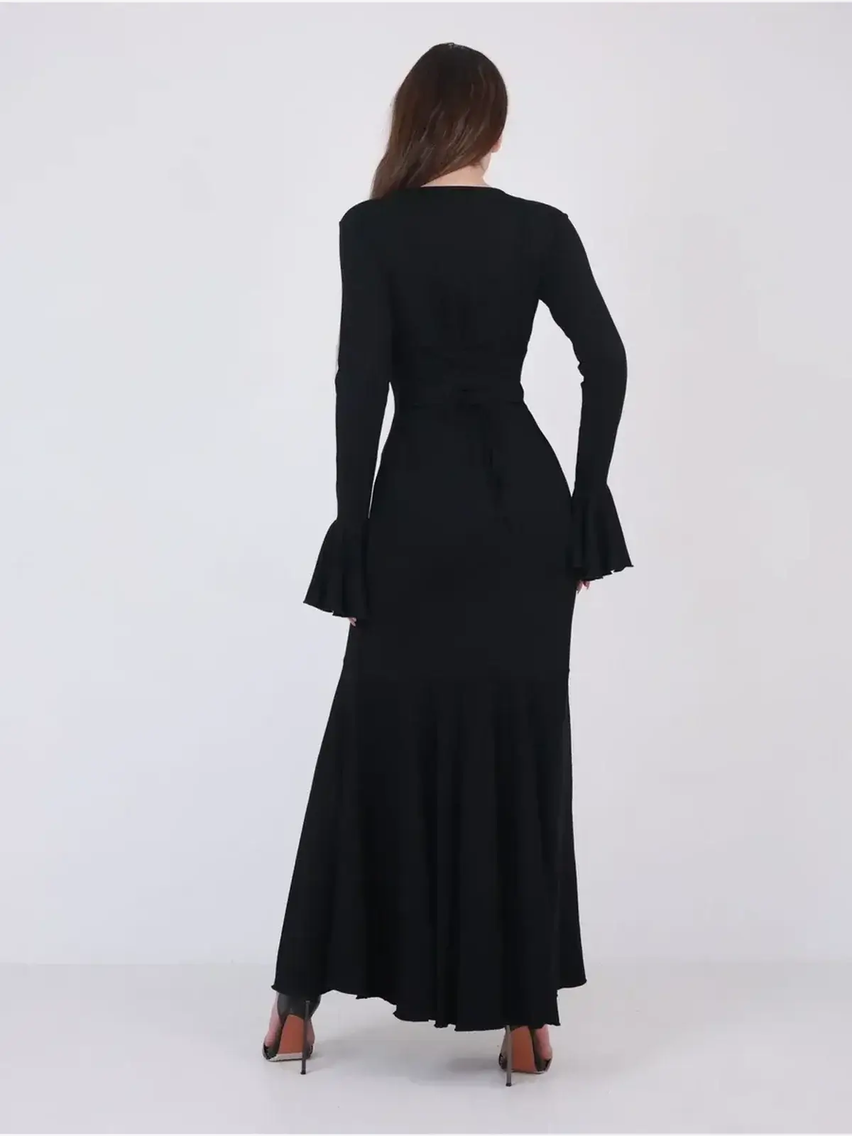 Back view of the elegant black Mirage Maxi Dress featuring flared cuffs and a fishtail hem, perfect for formal events.