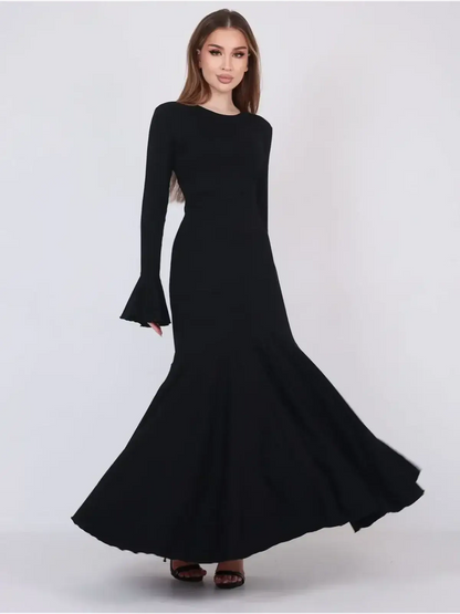 Mirage Maxi Dress in black, featuring flared cuffs and a fishtail hem for an elegant silhouette, perfect for evening wear.