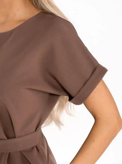 Close-up of Mocha Frame dress showcasing its sleek short sleeves and structured design in rich taupe tones.