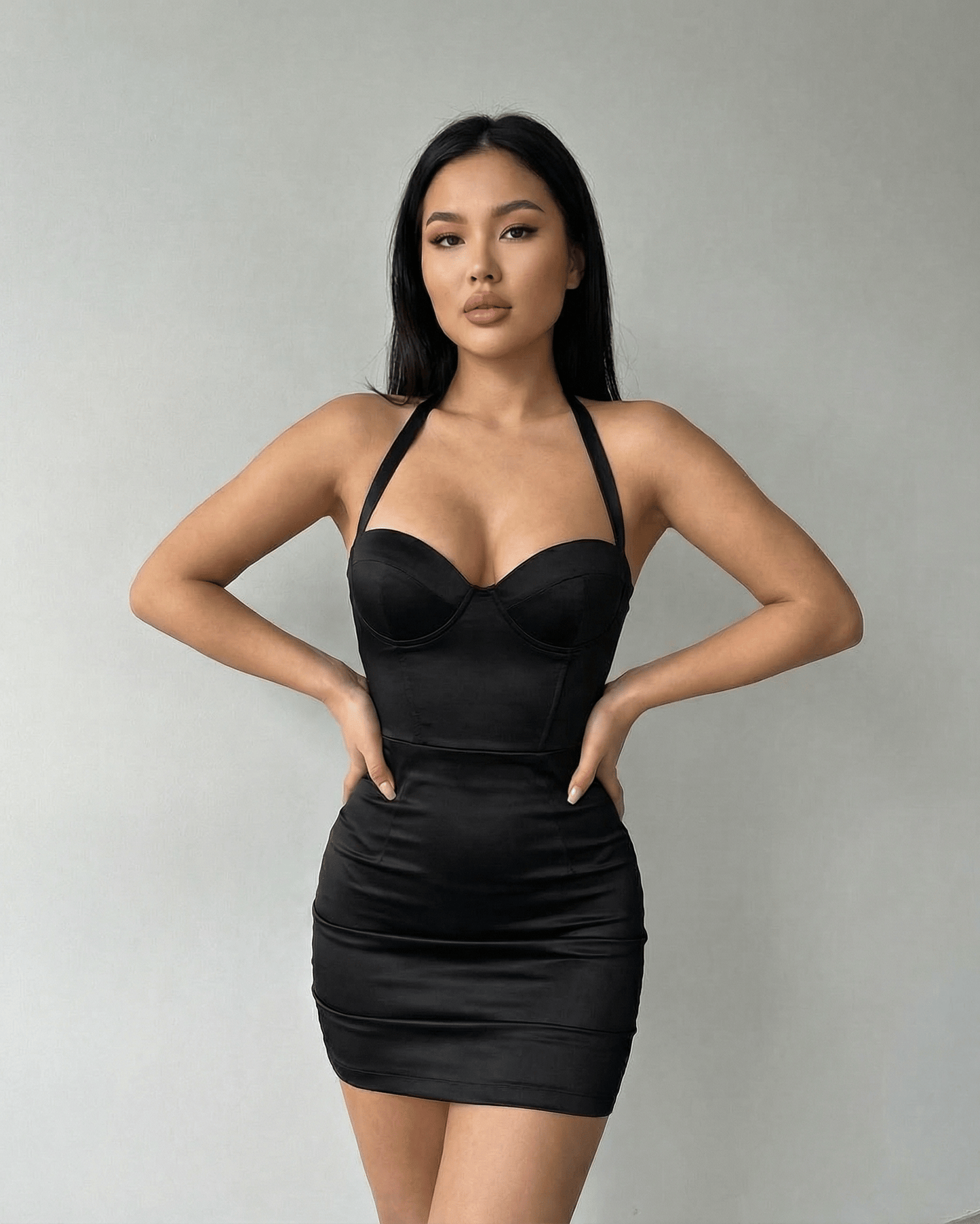 Model wearing Lauven Monaco Mini Dress – Black Satin Bodycon Halter Cocktail Mini Dress with sculpted cup detailing.