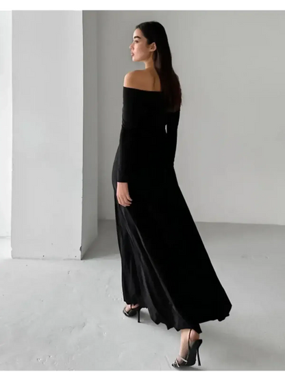 Elegant Muse Maxi Dress in black, showcasing off-shoulder design and flowing silhouette on a model.