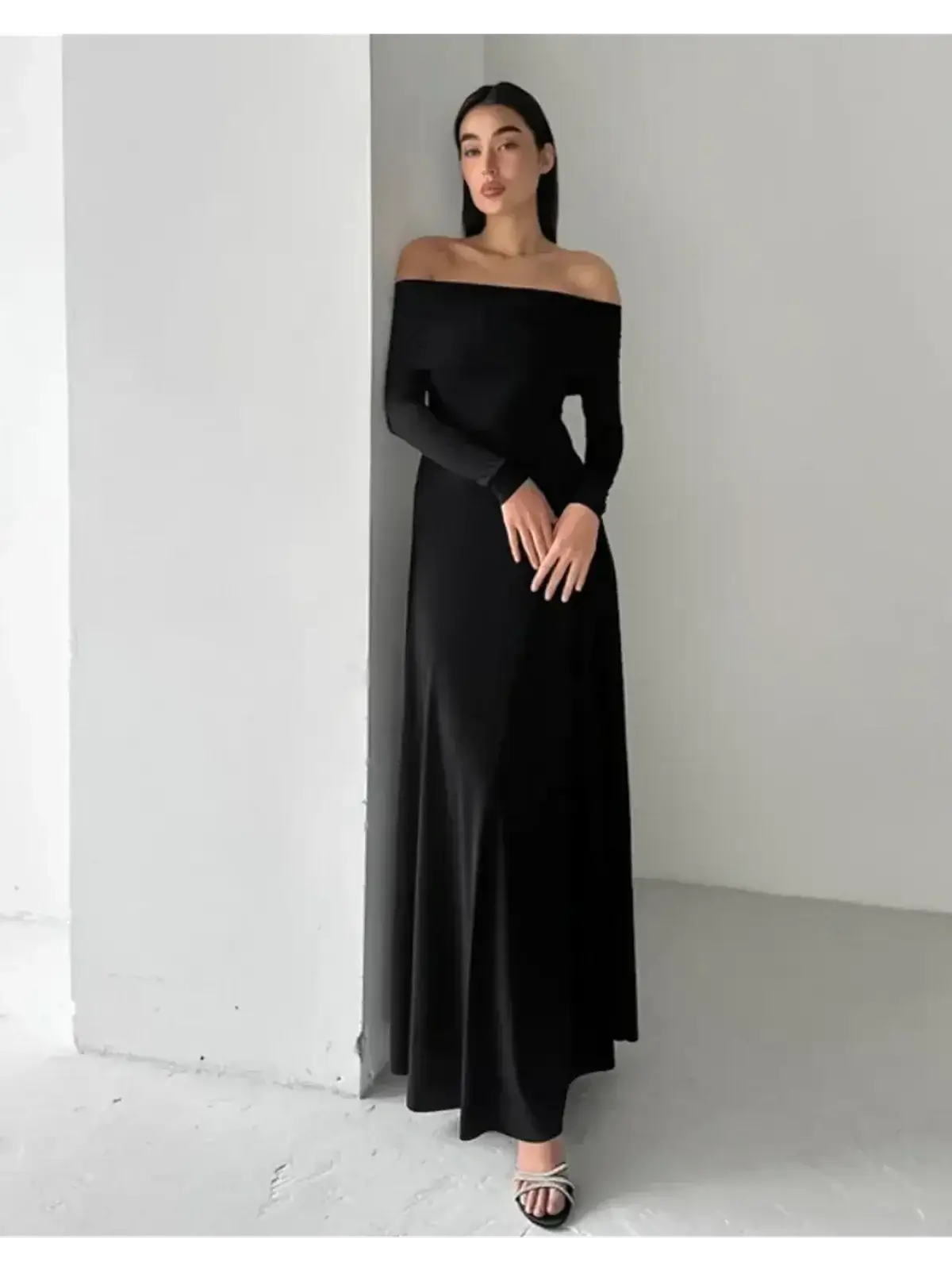 Off-shoulder Muse Maxi Dress in black, featuring a sleek fit and full-length skirt, perfect for elegant evening events.