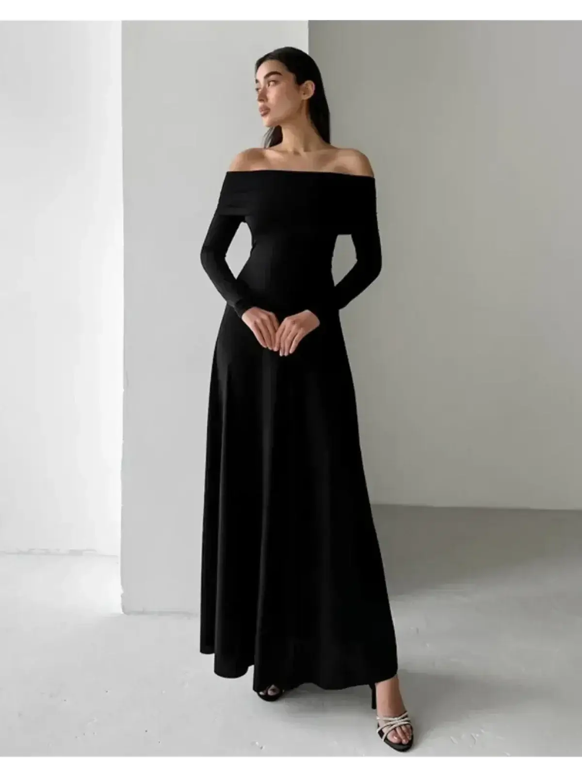 Muse Maxi Dress in black, featuring off-shoulder design and sleek, sculpting fit for elegant evening wear.