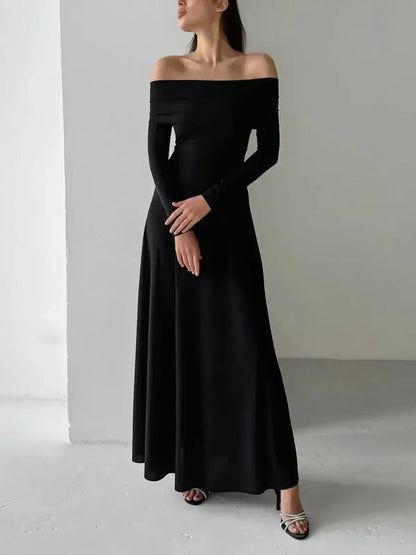 Elegant Muse Maxi Dress in black, featuring off-shoulder design and a sculpting fit, perfect for evening wear.