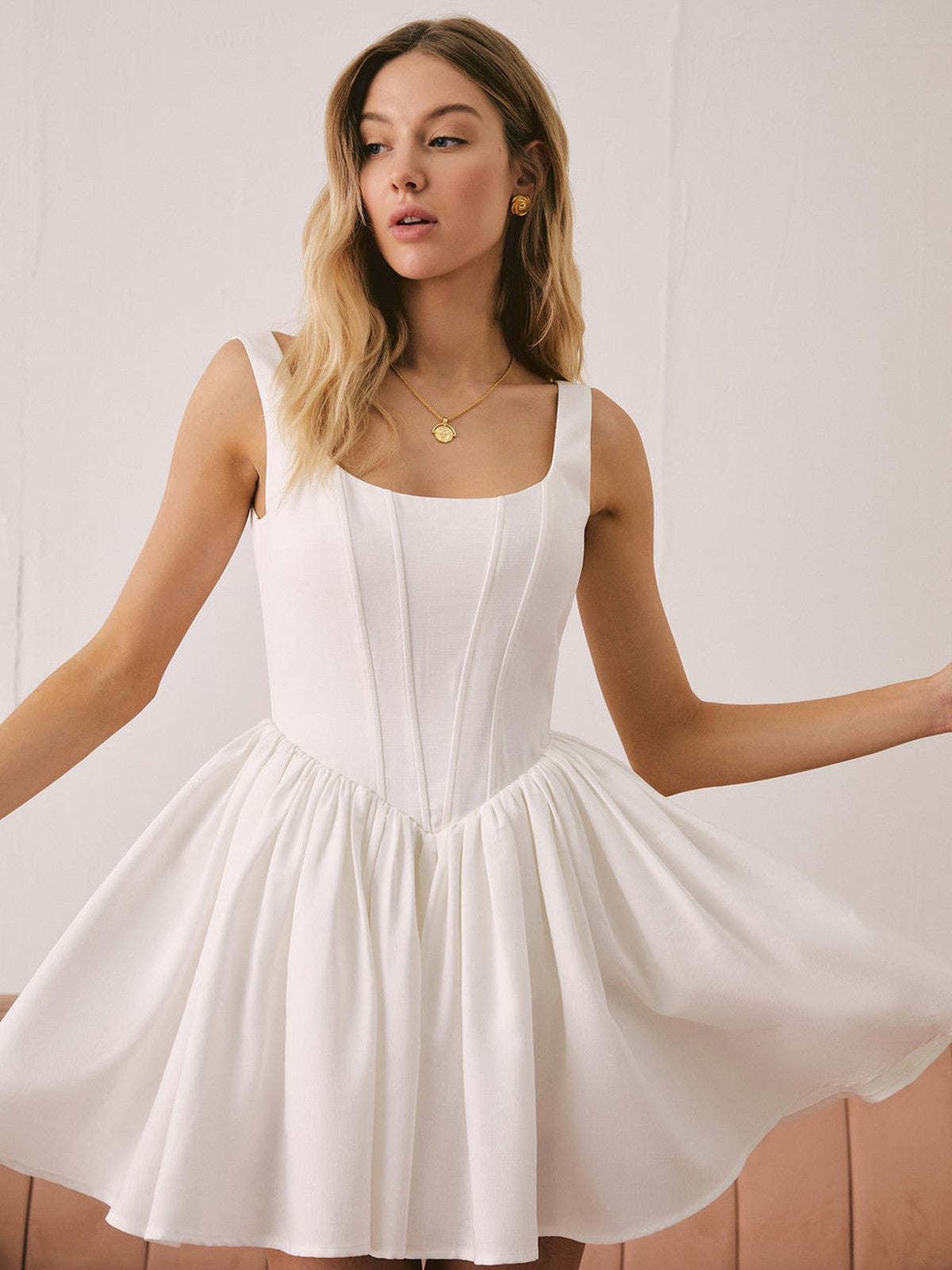Nell Mini Dress in white with sculpted design, perfect for weddings, parties, and summer outings.