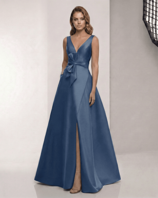 Noctra Maxi Dress - Elegant satin navy blue A-line dress featuring a V-neck and bow detail, perfect for formal occasions.