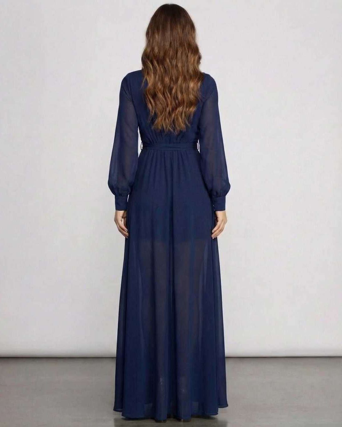Back view of Noctra Maxi Dress in navy chiffon, showcasing long sleeves and elegant floor-length A-line silhouette by Lauven.