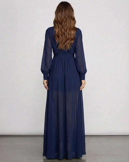 Back view of Noctra Maxi Dress in navy chiffon, showcasing long sleeves and elegant floor-length A-line silhouette by Lauven.