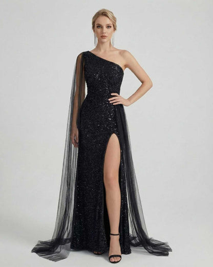 Nocturne Maxi Dress by Lauven – One shoulder sequin black dress with sheer mesh drape and side slit.